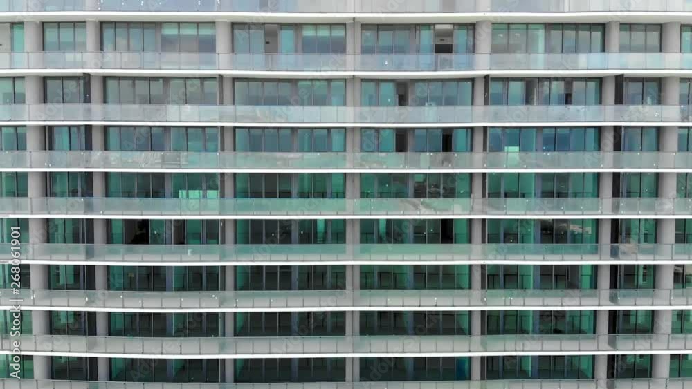 Drone rising facing high rise building in downtown Miami. Metallic building. Urban scene. Over looks Miami. Drone rising facing high rise building in downtown Miami. Metallic building. Urban scene. Over looks Miami.