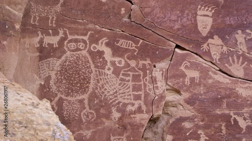 Panning across big petroglyph panel with bear paw with claws and giant owl in Nine Mile Canyon. photo