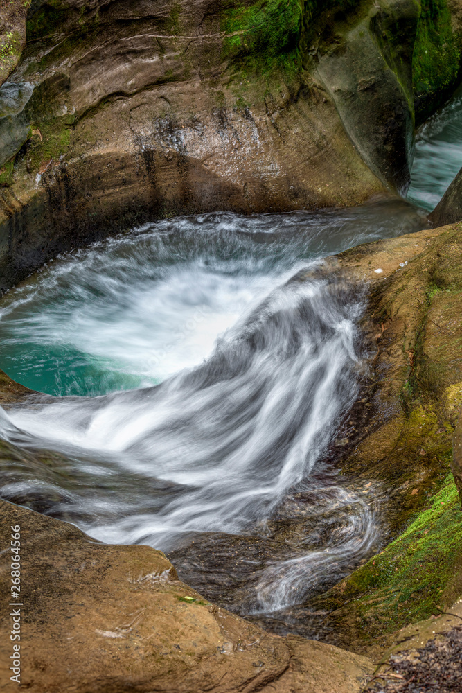 Whitewater on Sandstone - Water swirls and splashes through a sandstone chute called the Devil’s Bathtub in the Old Man’s Cave area of Ohio’s Hocking Hills State Park.