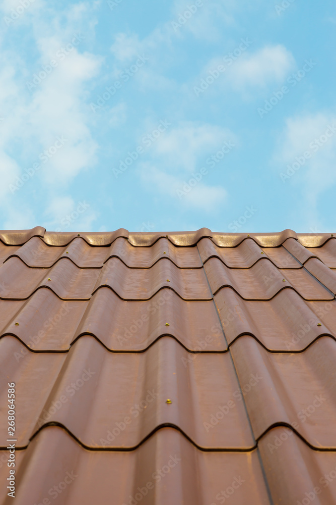 Roof house with tiled roof on blue sky Roof house with tiled roof on blue sky