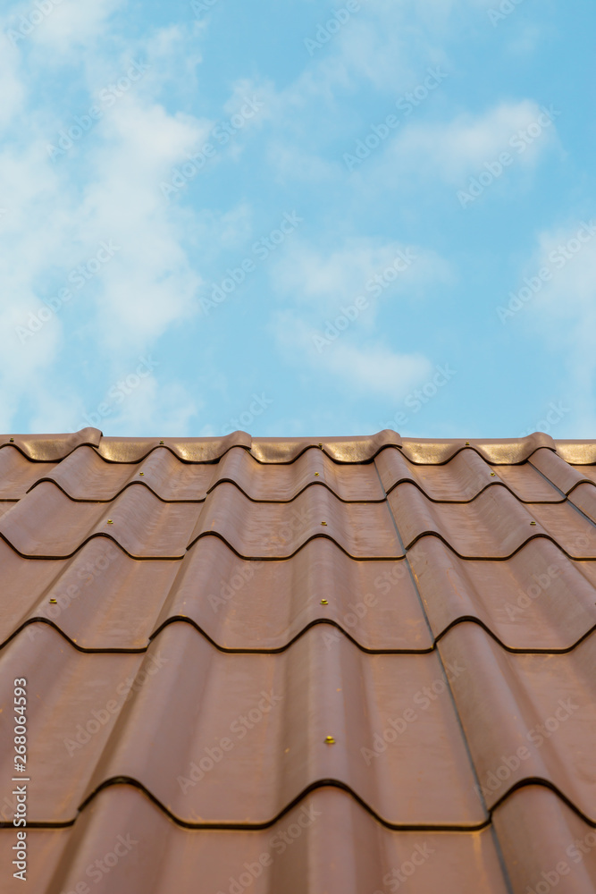 Roof house with tiled roof on blue sky