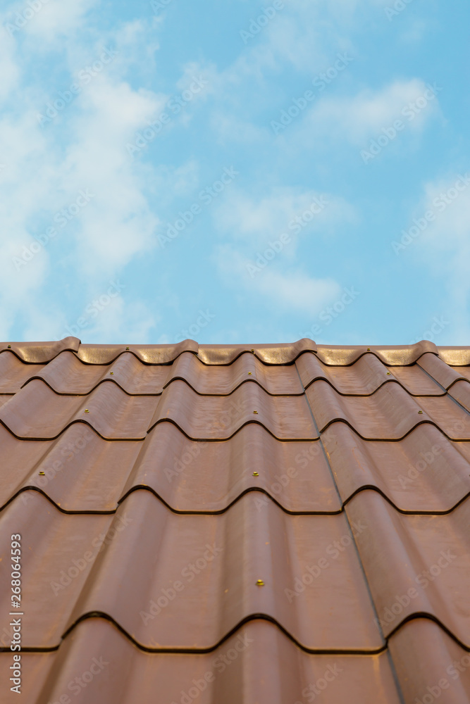 Roof house with tiled roof on blue sky Roof house with tiled roof on blue sky