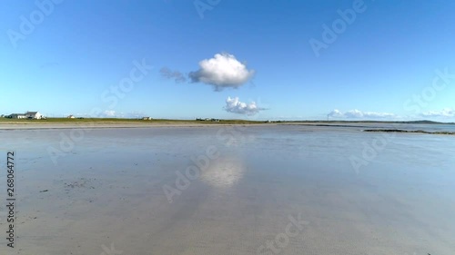 Blue sky reflecting on beach at low tide on Isle of Tiree photo