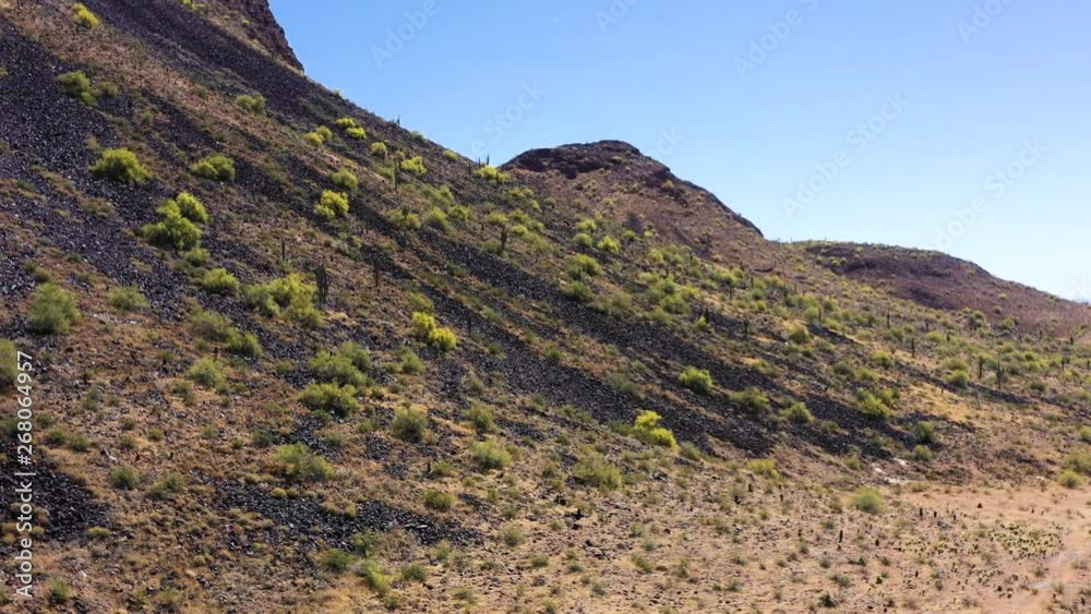 Aerial pan along the base of a desert mountain, Scottsdale, Arizona. Concept: desert,mountains,travel Aerial pan along the base of a desert mountain, Scottsdale, Arizona. Concept: desert,mountains,travel