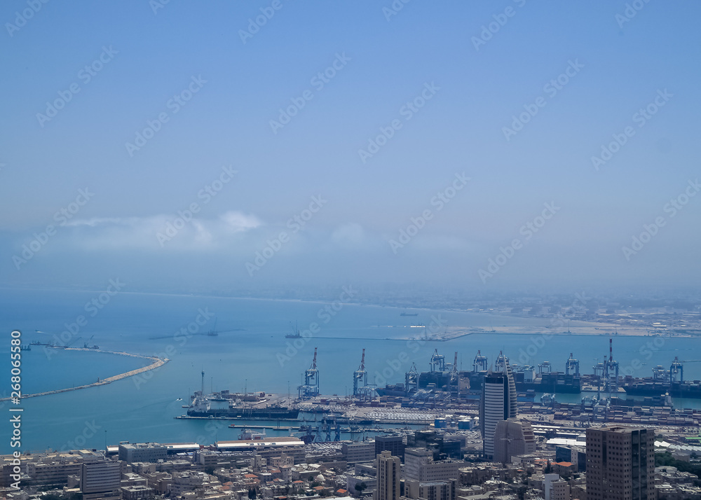 Port of Haifa, naval port on Mediterranean Sea, where cargo ships travel through heat haze