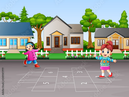 Happy children playing hopscotch in the yard