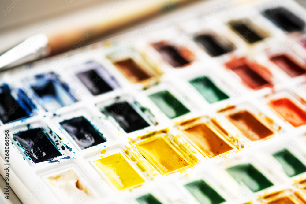 Set watercolor paints with paintbrush. Art concept