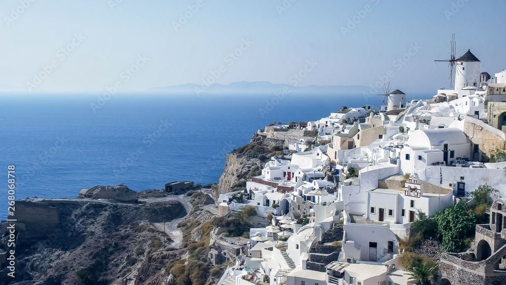 wide view of the windmills and houses in oia, santorini