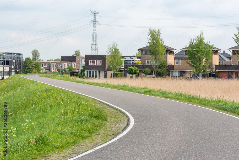 Empty curved road on a dam in the dutch countryside, Capelle Aan Den Ijssel, Netherlands