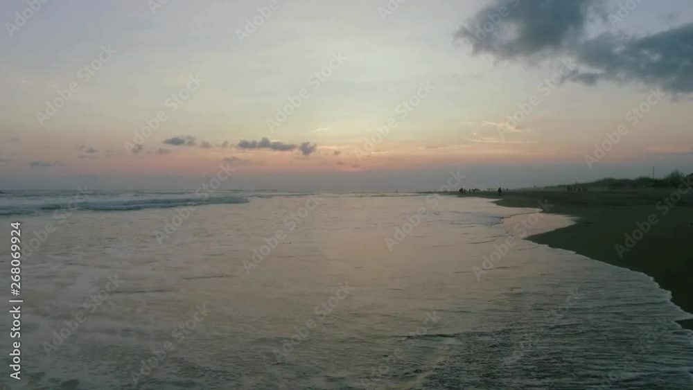 Walking trough in the side of the beach while sunset calm wave stock footage Walking trough in the side of the beach while sunset calm wave stock footage