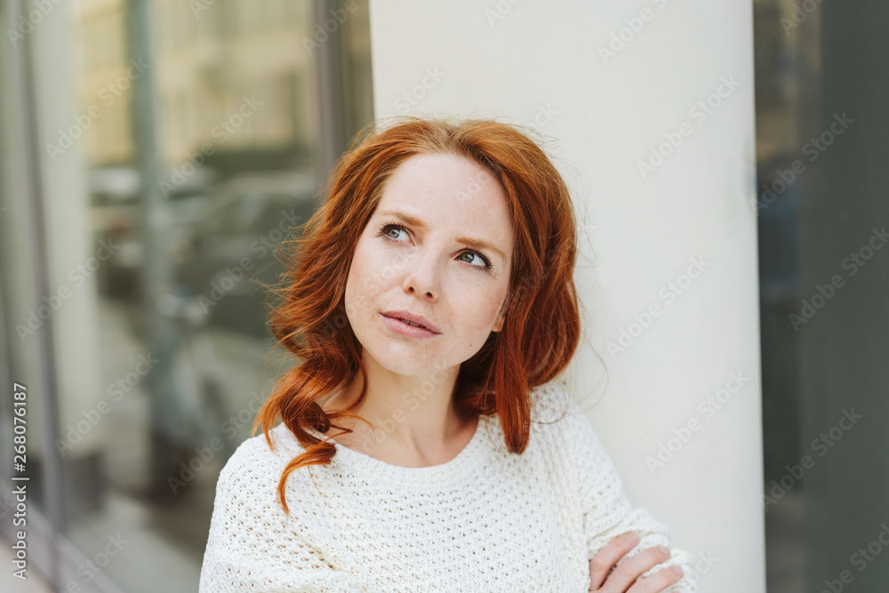 Fototapeta premium Young woman standing thinking deeply