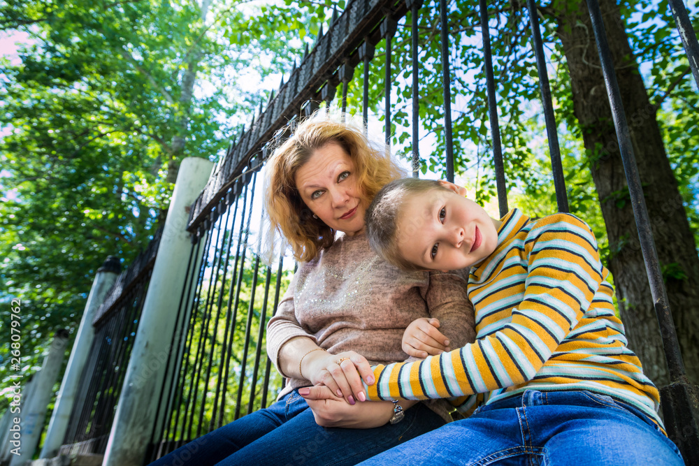 Obraz premium Mom and son having fun in the park