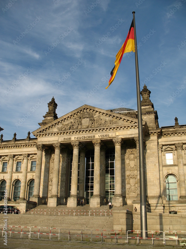Obraz premium Reichstag building in Berlin, Germany and German flag in front