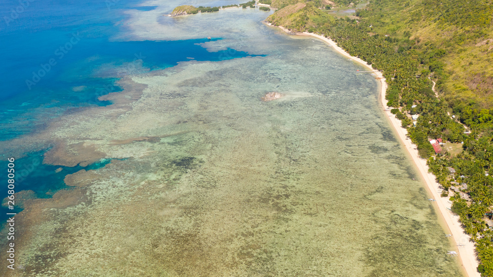 Seacoast with coral reef and white beach.Lagoon with coral reef and clear water, top view.aerial view