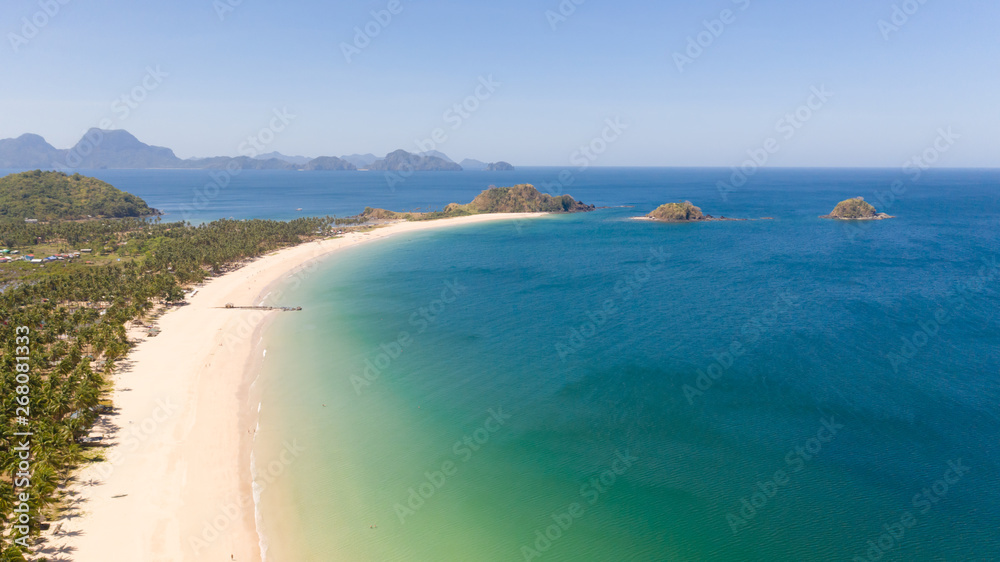 Beautiful island with a lagoon and a white beach. Seascape with islands in clear weather.Philippines El Nido aerial view Nacpan Beach