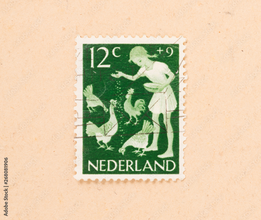 THE NETHERLANDS 1960: A stamp printed in the Netherlands shows a child feeding chickens, circa 1960