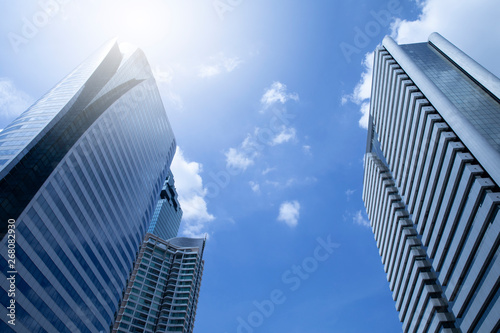 modern business building with flare light blue sky background