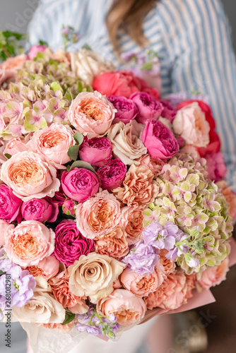 Large Beautiful bouquet of mixed flowers in woman hand. Floral shop concept . Beautiful fresh cut bouquet. Flowers delivery