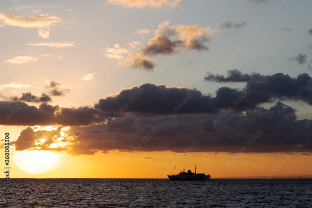 passenger ship that sails in a bright yellow sunset near the Istanbul Islands