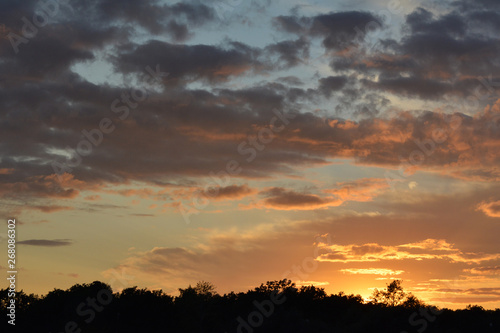 Beautiful sunset sky with dramatic light. Cloudscape in summer evening.