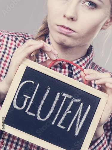 Angry woman holding board with gluten sign
