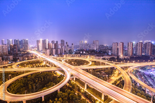 urban overpass at dusk, modern city skyline and traffic background.Wuhan, the largest transportation and economic hub city in central China. © HAIYAN