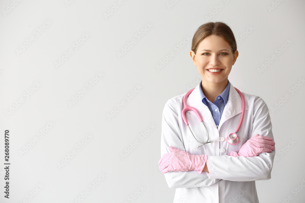 Portrait of young gynecologist on light background Portrait of young gynecologist on light background