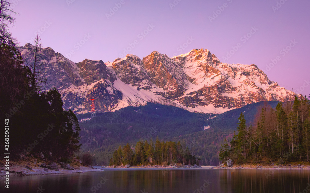 Impressive summer sunrise on Eibsee lake with Zugspitze mountain range. German Alps, Bavaria, Germany, Europe. Beauty of nature concept background.