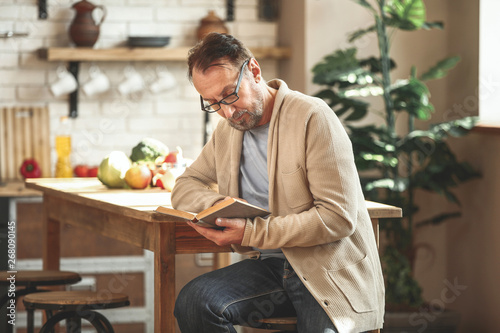 Handsome mature man reading...