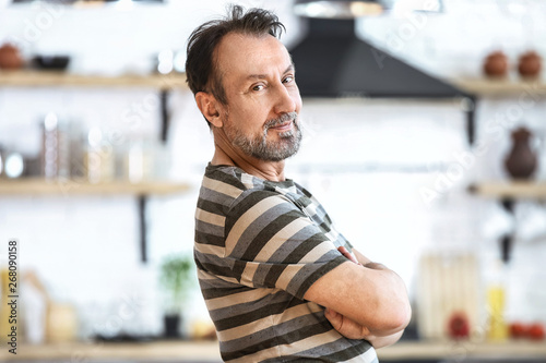 Handsome mature man in kitchen