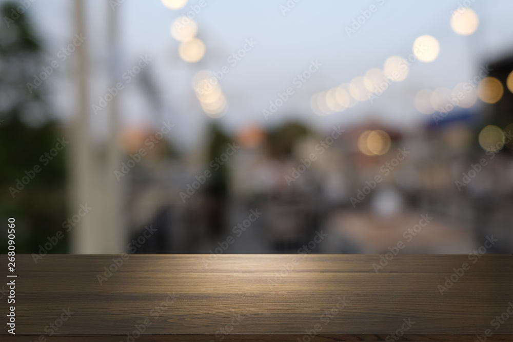 Empty dark wooden table in front of abstract blurred bokeh background of restaurant . can be used for display or montage your products.Mock up for space. Empty dark wooden table in front of abstract blurred bokeh background of restaurant . can be used for display or montage your products.Mock up for space.