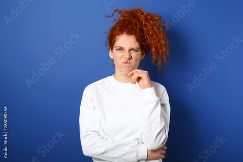 Disgusted redhead woman on ...