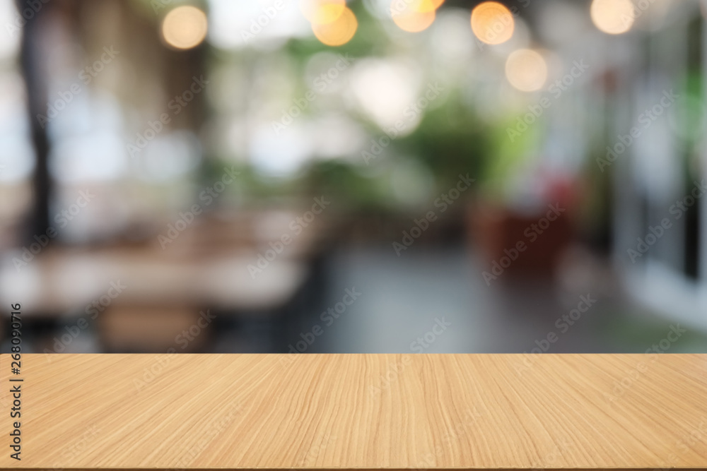 Empty dark wooden table in front of abstract blurred bokeh background of restaurant . can be used for display or montage your products.Mock up for space.