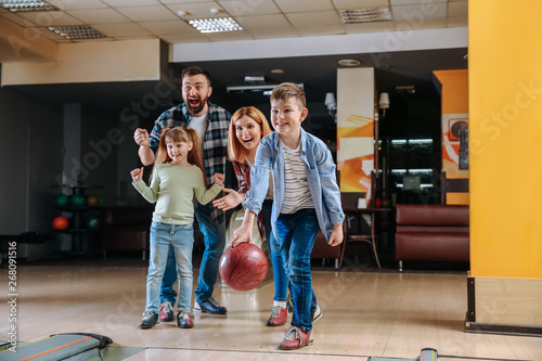 Family playing bowling in club