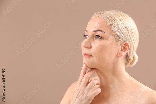Mature woman on color backg...