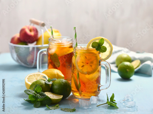 Iced tea with lemons, limes and mint with ice cubes, summer refreshment drink