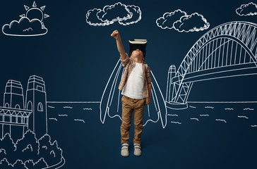 Painted dream about being superhero and saving the city. Little boy or child with virtual reality headset glasses. Concept of cutting edge technology, video games, innovation, childhood, dreams.