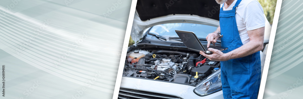 Mechanic using laptop for checking car engine. panoramic banner Mechanic using laptop for checking car engine. panoramic banner