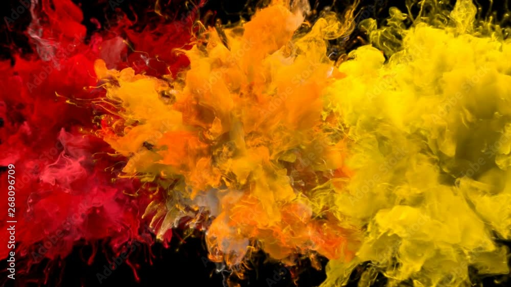 Red, Orange, Yellow Color Burst - Multiple colorful smoke powder explosion fluid ink particles slow motion alpha matte isolated on black