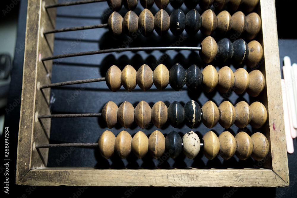 Obsolete wooden abacus, black background Obsolete wooden abacus, black background
