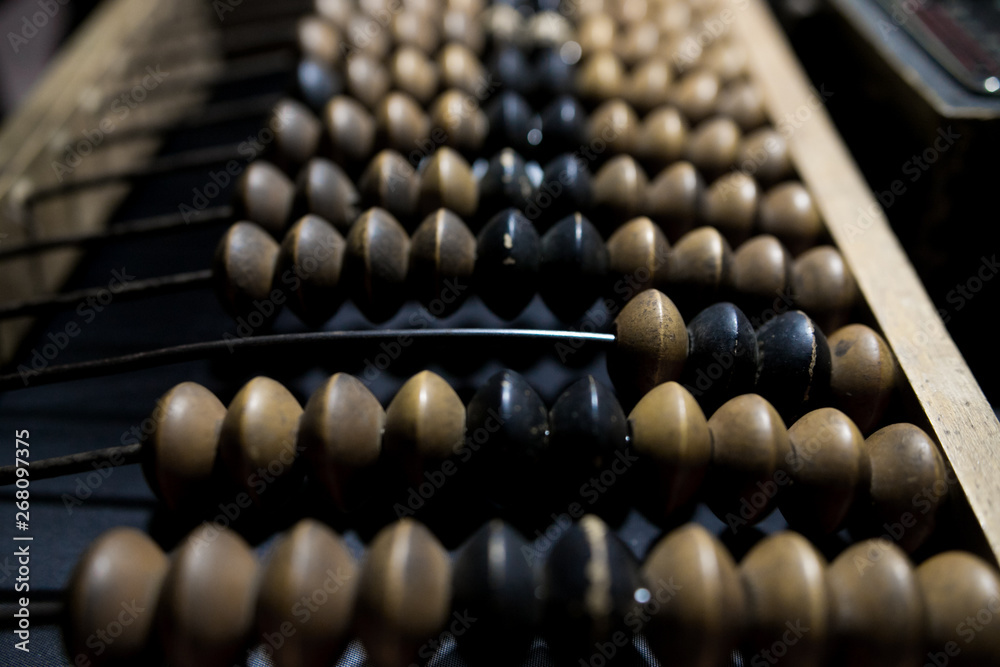 Obsolete wooden abacus, black background Obsolete wooden abacus, black background