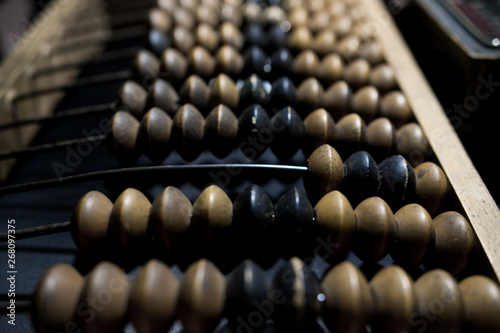 Obsolete wooden abacus, black background