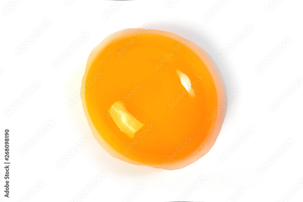 Raw egg yolk on a white background. Close-up. View from above. Protein