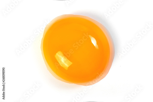 Raw egg yolk on a white background. Close-up. View from above. Protein photo