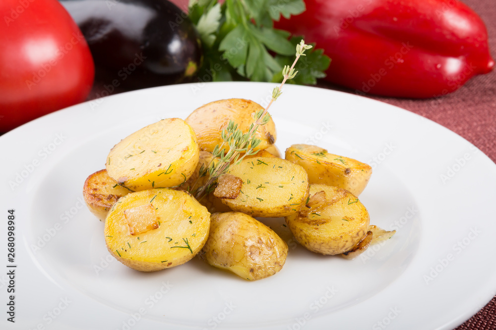 Baked yellow potatoes as garnish served with thyme Baked yellow potatoes as garnish served with thyme