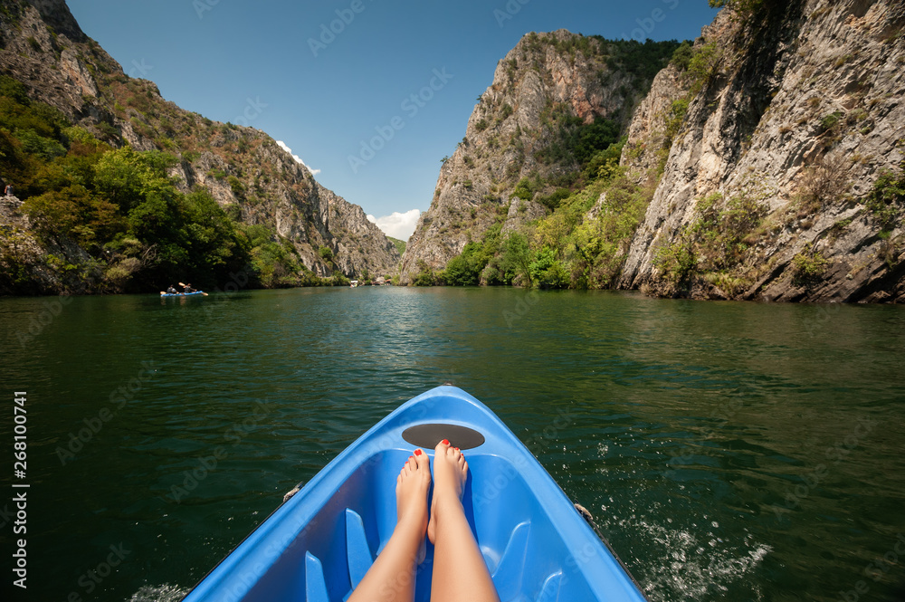 Kayaking through river in Matka canyon, Macedonia. Woman legs in the blue  kayak Stock Photo | Adobe Stock