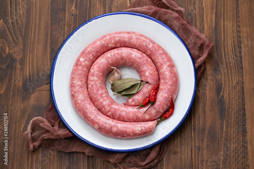 typical spanish sausage on white dish on wooden background