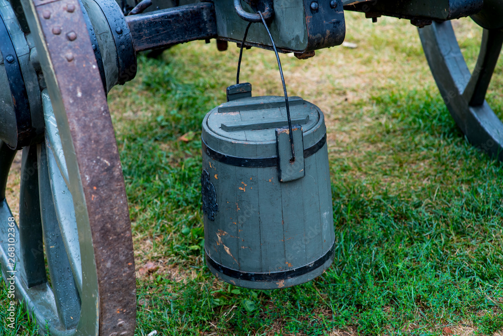 Wooden bucket attached to an ancient cannon. Wooden bucket attached to an ancient cannon.