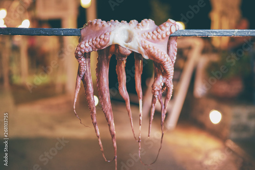 Fototapeta Naklejka Na Ścianę i Meble -  Octopus tentacles dried in a Greek tavern on the street in Greece.