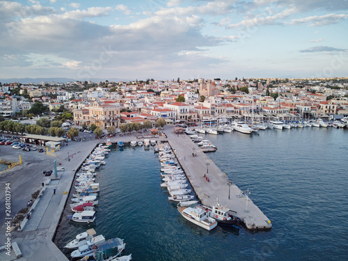 Aerial drone bird's eye view of famous and picturesque port of Aegina island with fishing boats docked and Yachts, Saronic gulf, Greece © luengo_ua
